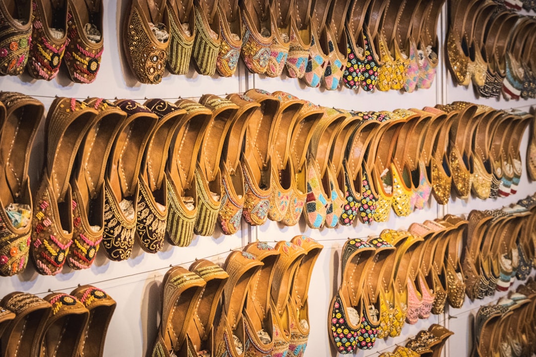 Rows of ornate, traditional leather shoes displayed for sale
