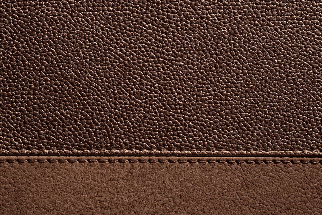 Brown leather with stitching, creating a textural look