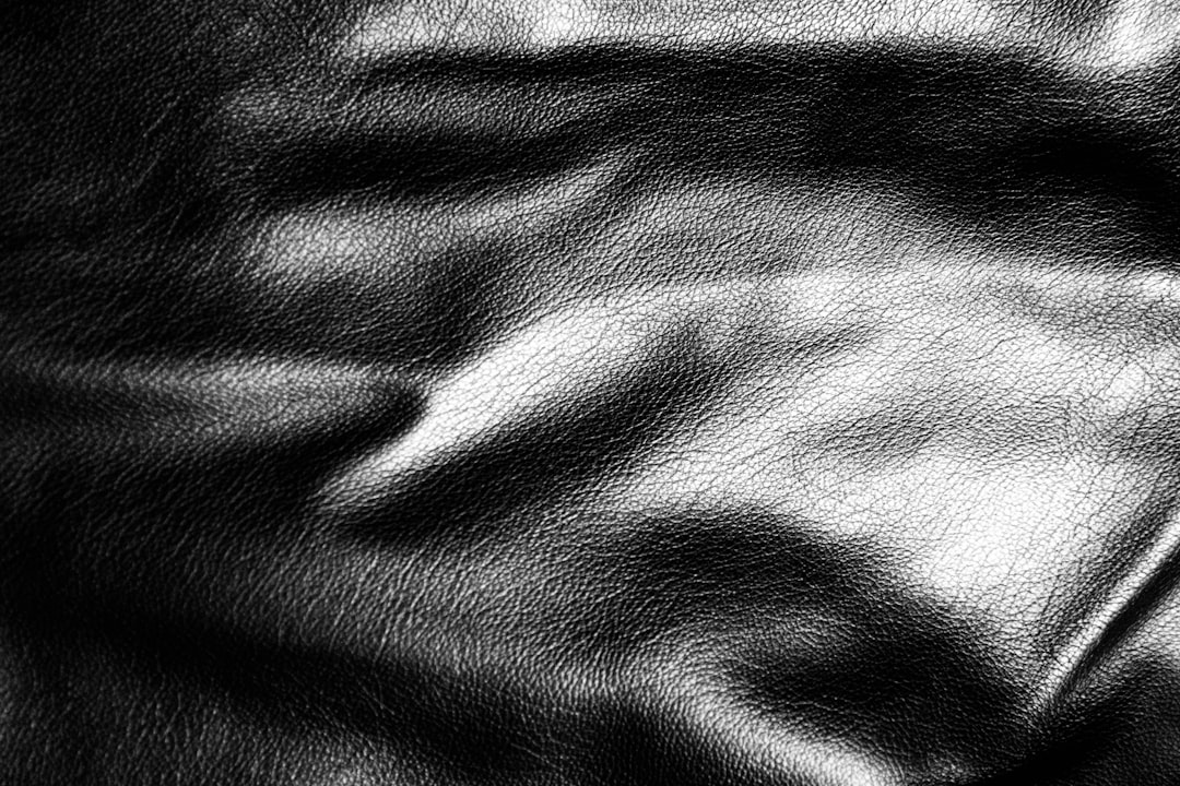 Close-up of black leather texture with wrinkles